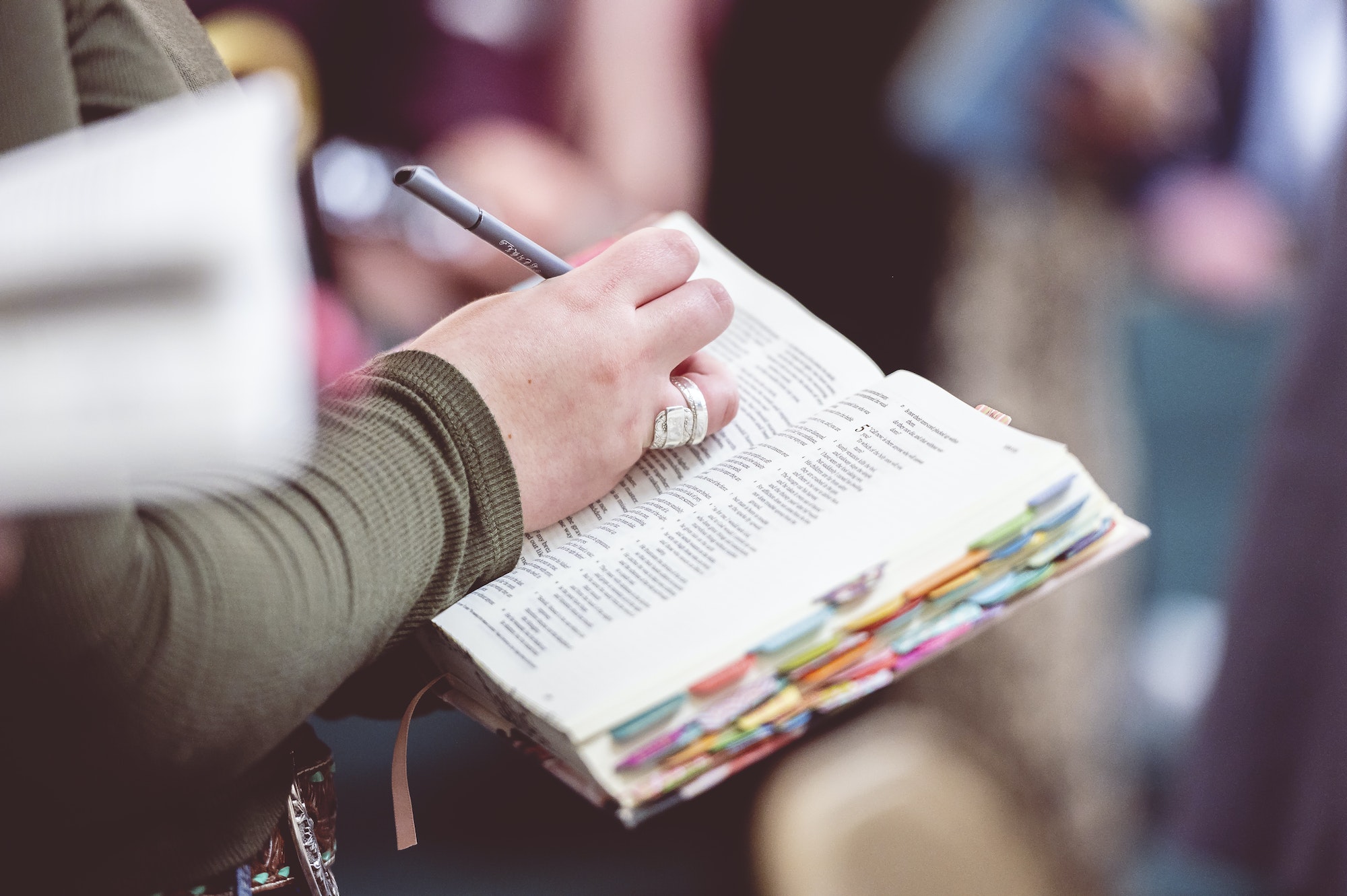 Woman making notes in the Bible