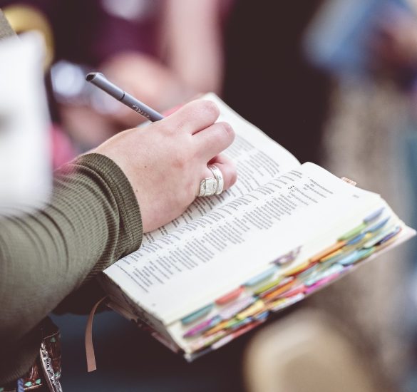 Woman making notes in the Bible